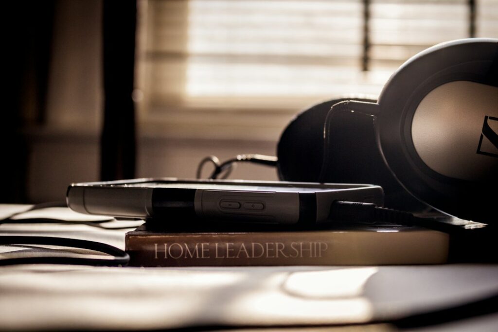 Headphones resting on a stack of books